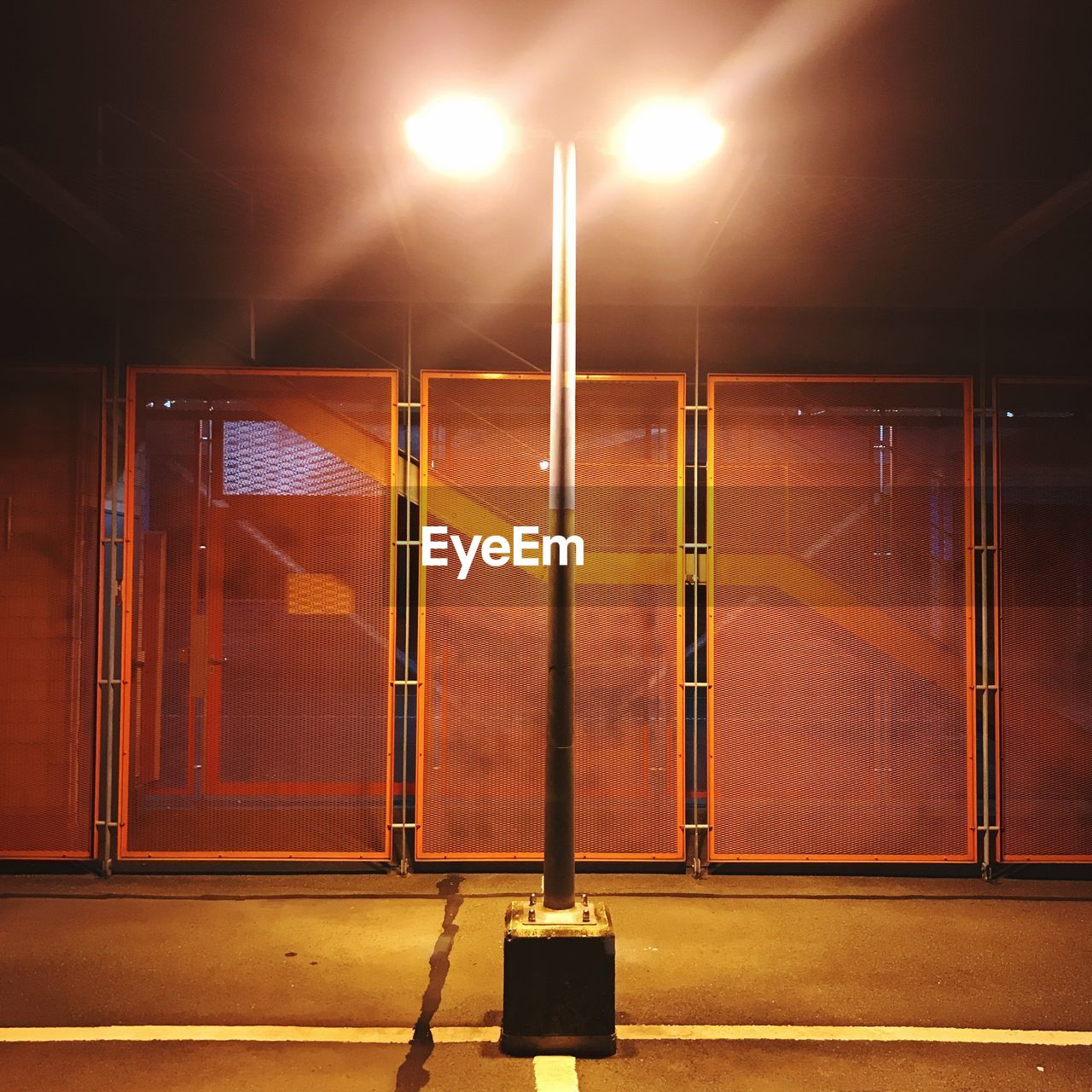 Illuminated street lights on road at night