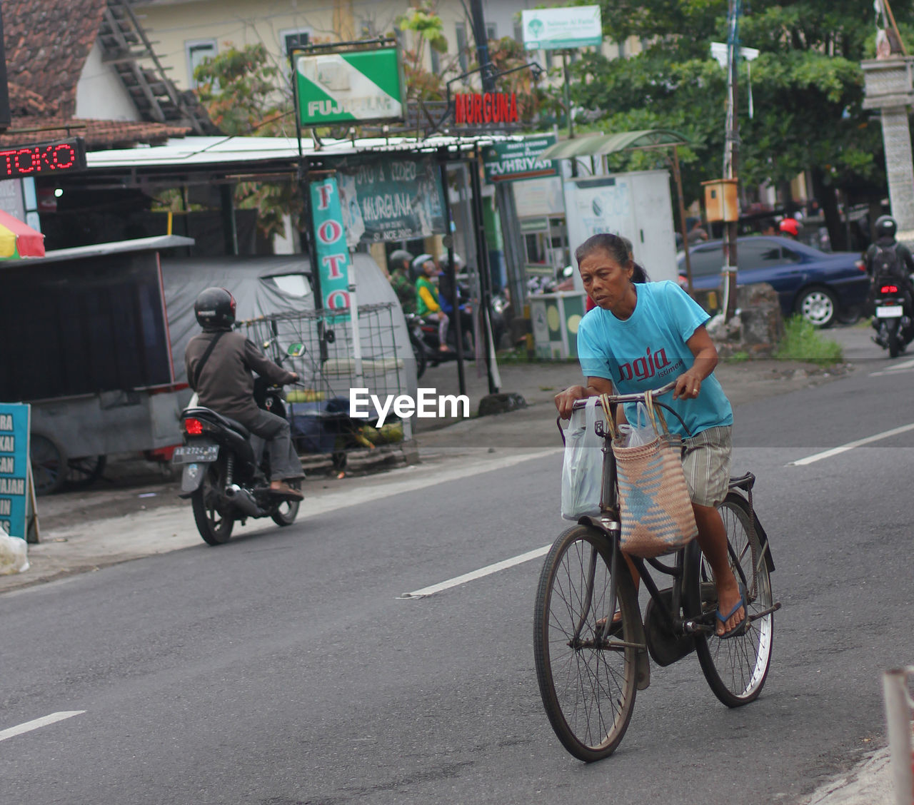 PEOPLE RIDING BICYCLE ON ROAD