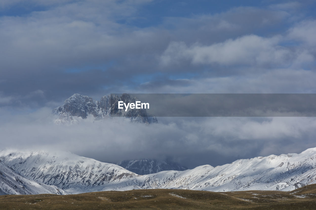 Scenic view of snowcapped mountains against sky