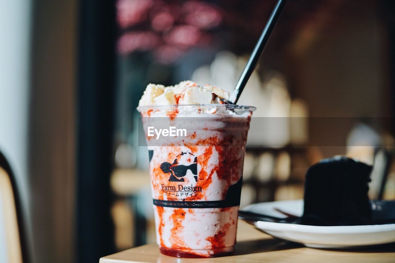 CLOSE-UP OF ICE CREAM IN GLASS ON TABLE