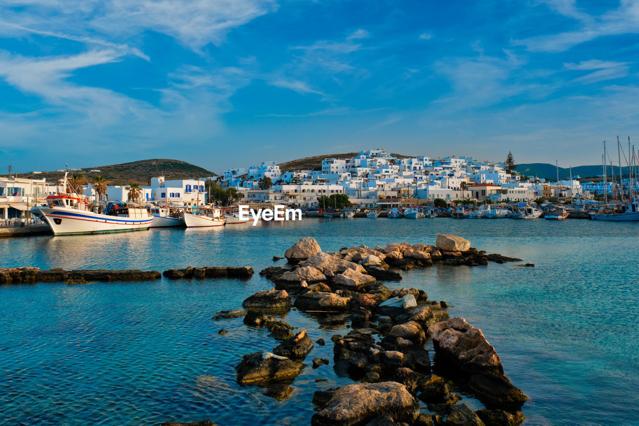 SCENIC VIEW OF SEA BY CITY AGAINST SKY