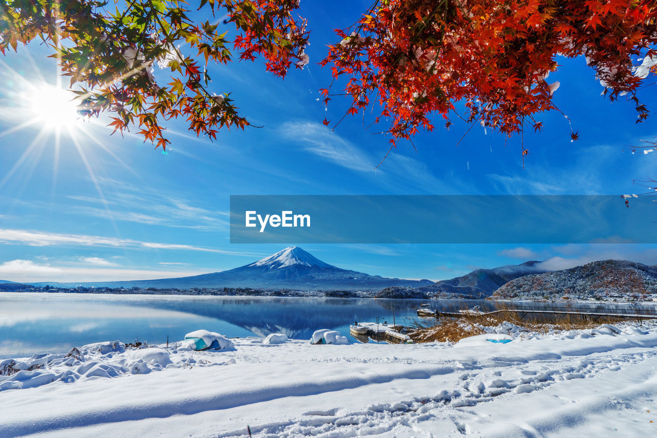 Scenic view of snowcapped mountains against blue sky