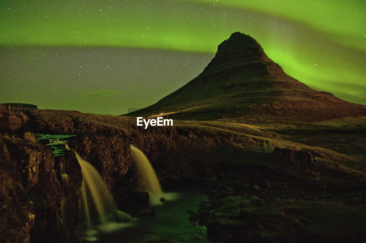 The sky was lit up by magnificent northern light at this iconic mountain of iceland.