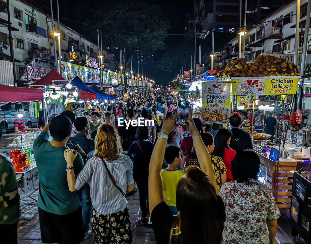 Group of people on street market at night