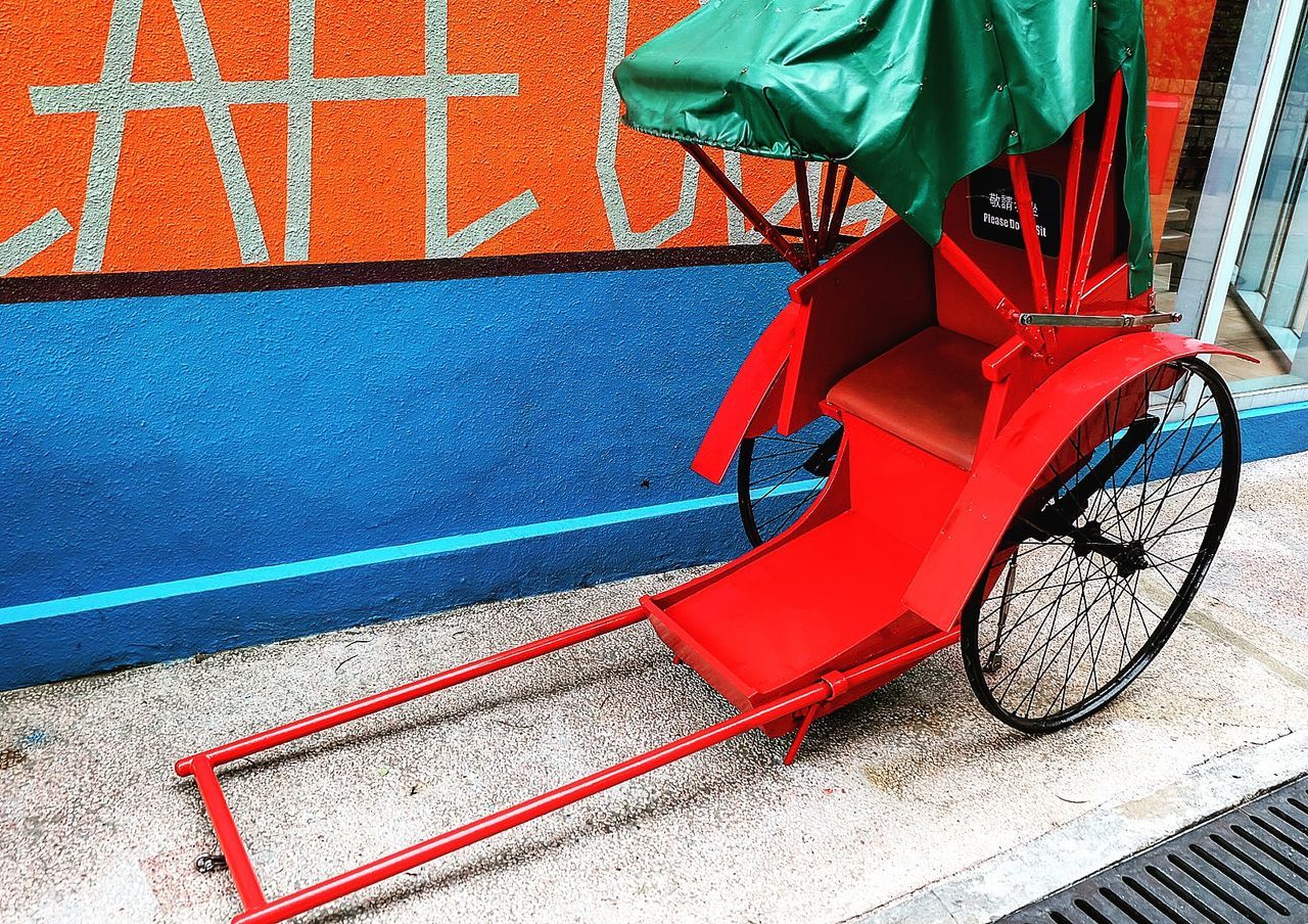 Pedicab parked against wall