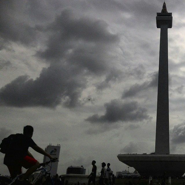 TOURISTS AT CLOUDY SKY