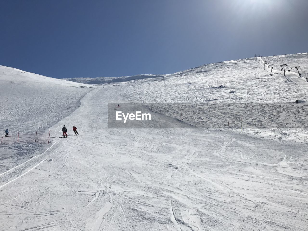 People on snowcapped mountain against sky