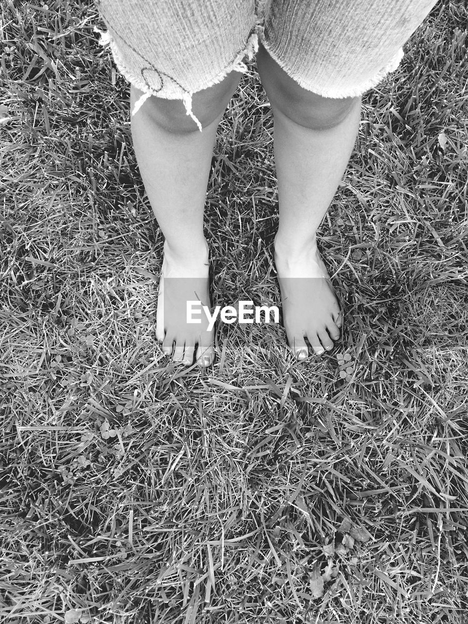 LOW SECTION OF WOMAN STANDING ON GROUND