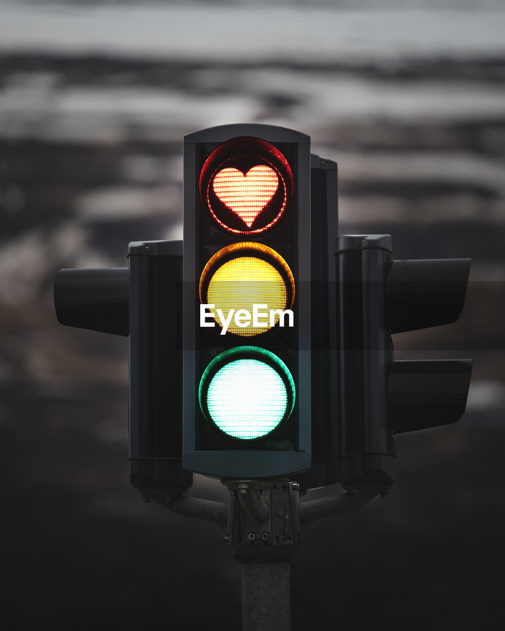 Iconic heart shaped stop light in traffic signal. red light displaying love symbol..