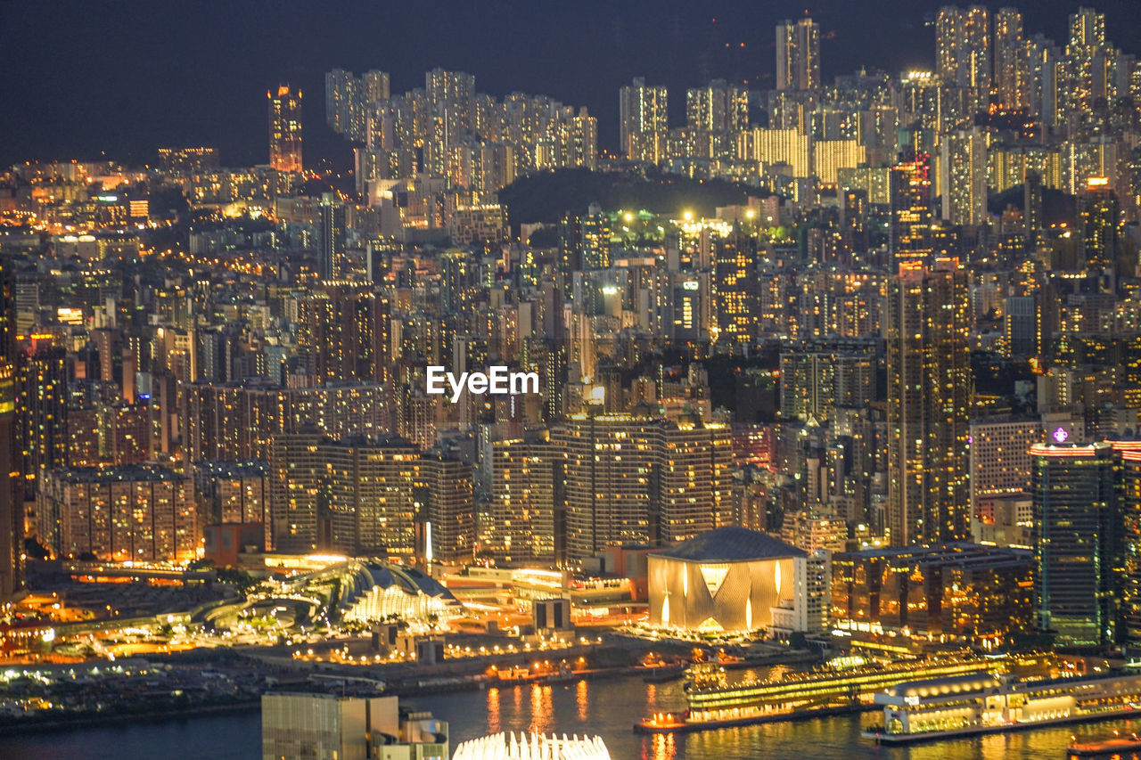 high angle view of illuminated buildings in city at night