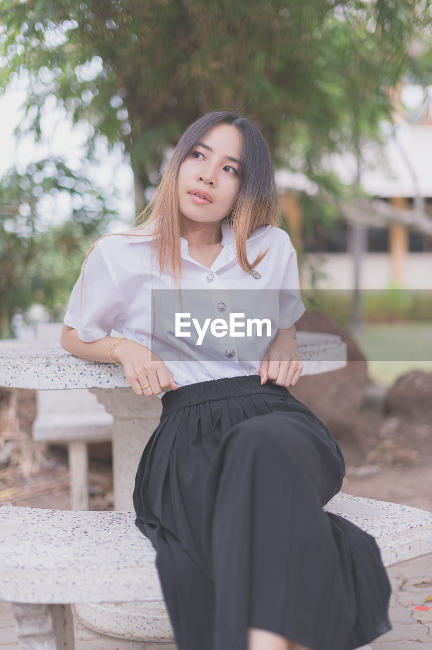 Young woman sitting on bench