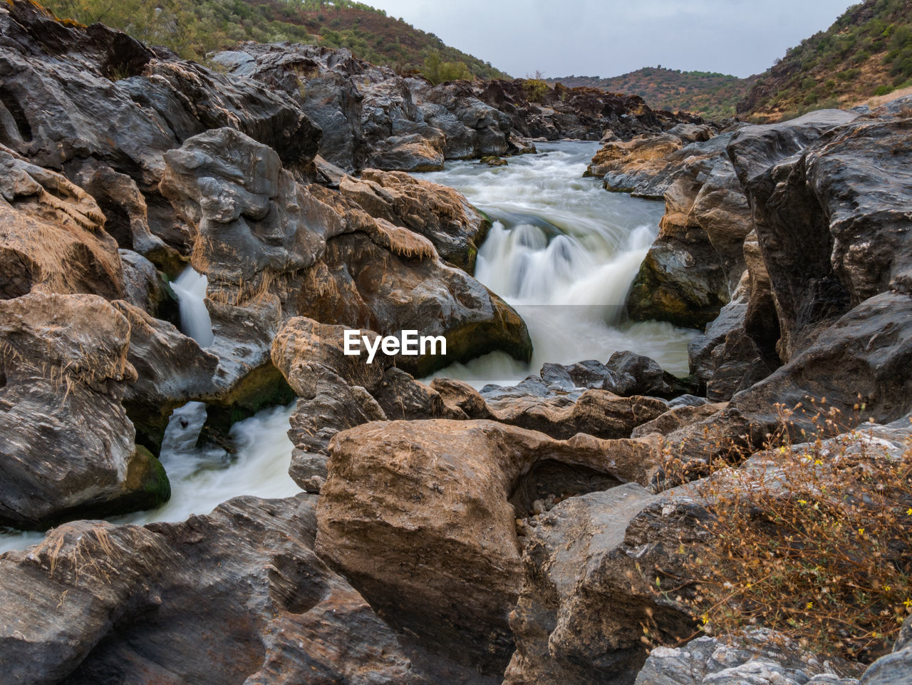 RIVER FLOWING AMIDST ROCKS