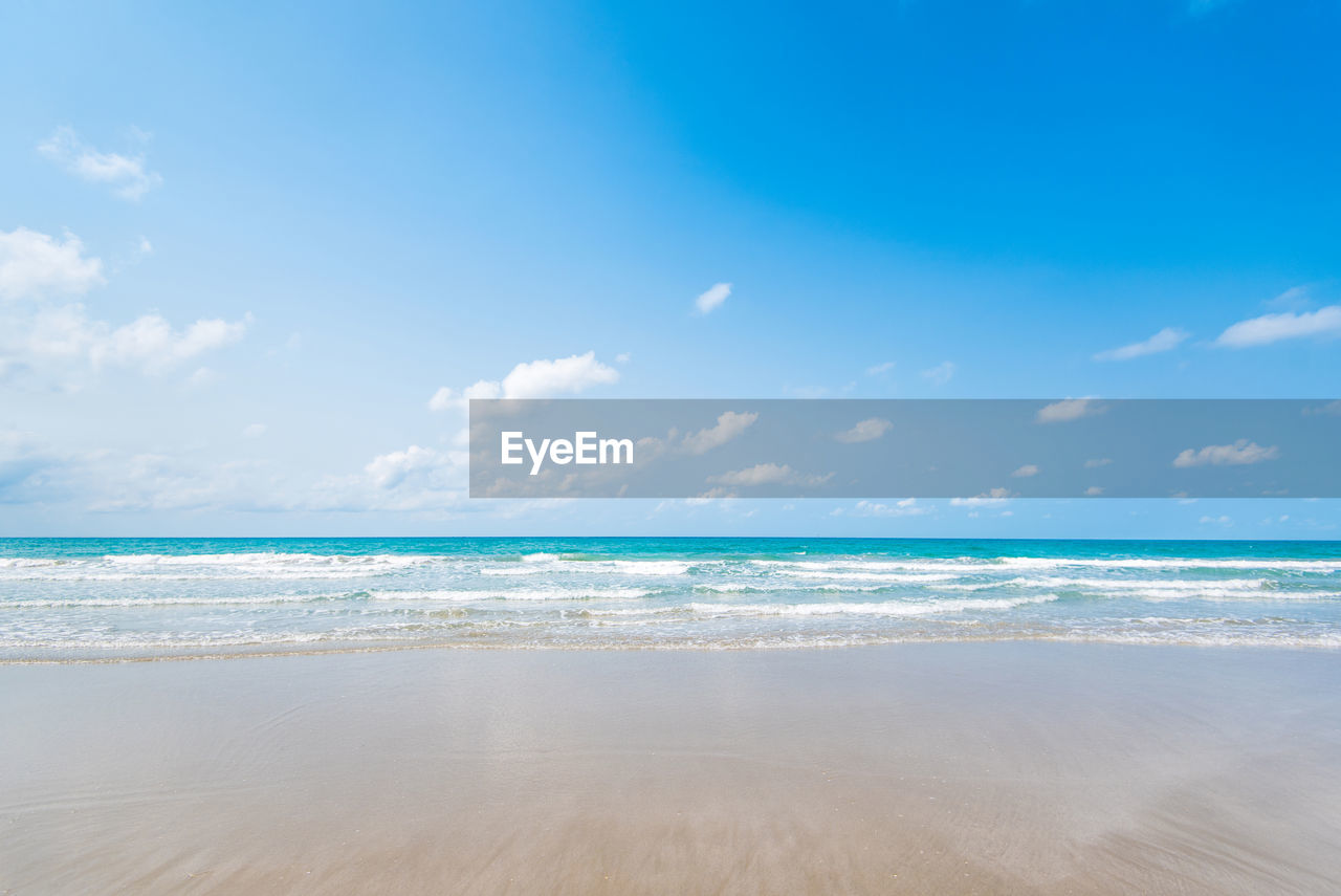 SCENIC VIEW OF BEACH AGAINST BLUE SKY