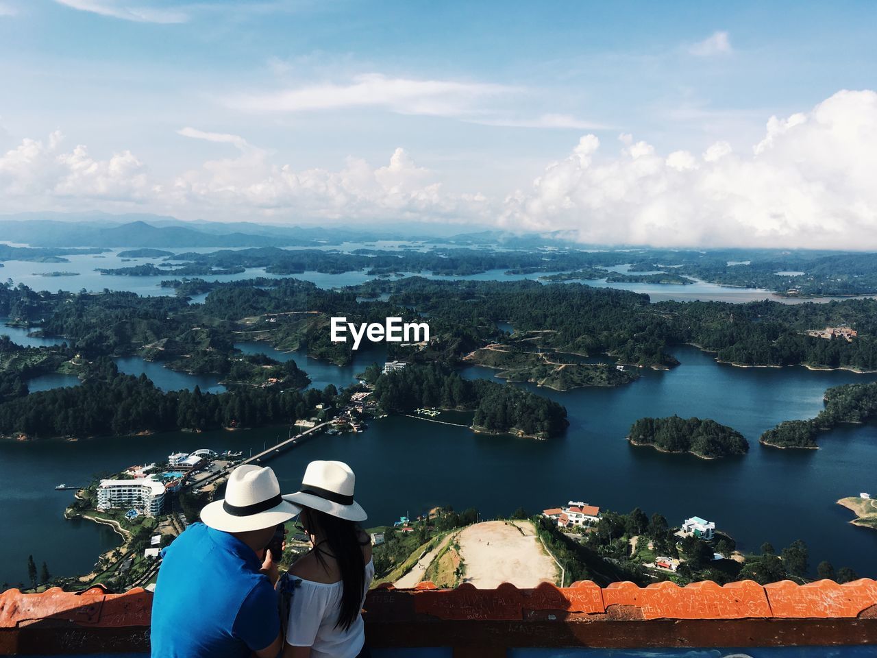 Rear view of couple looking over sea against sky