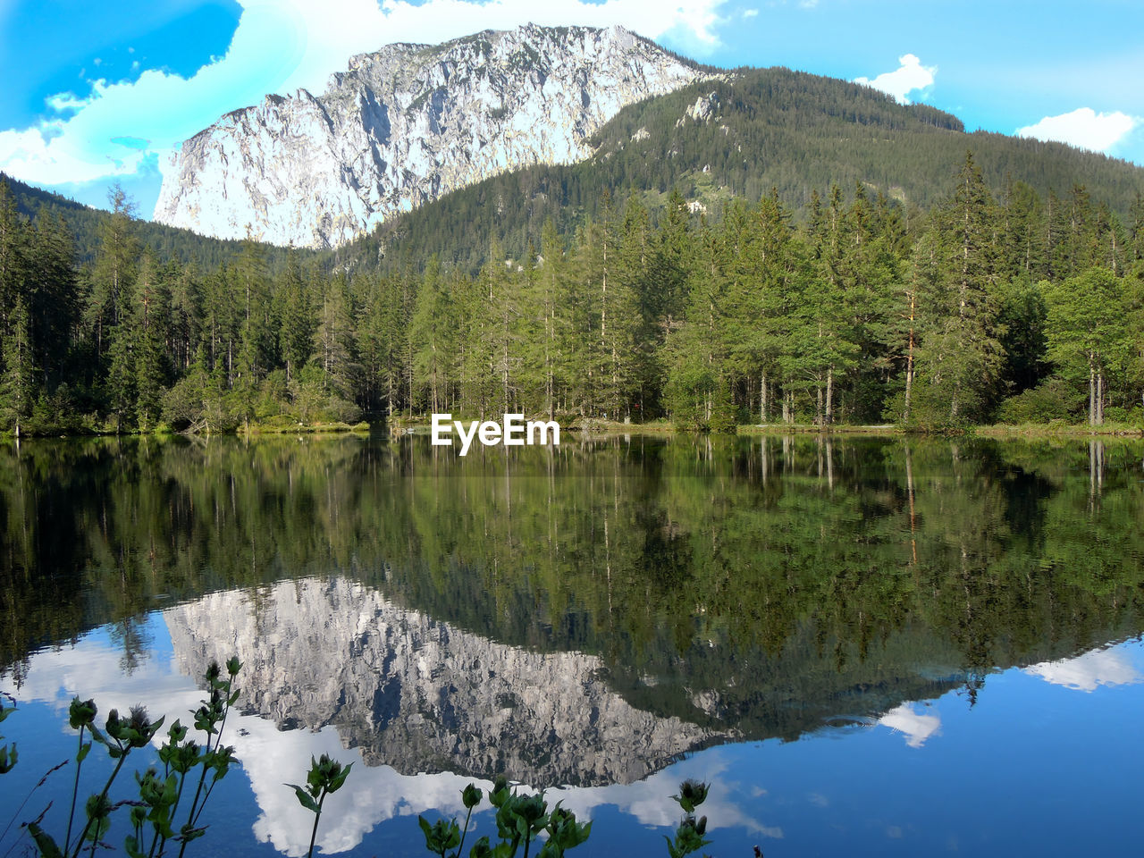 Scenic view of lake and mountains against sky