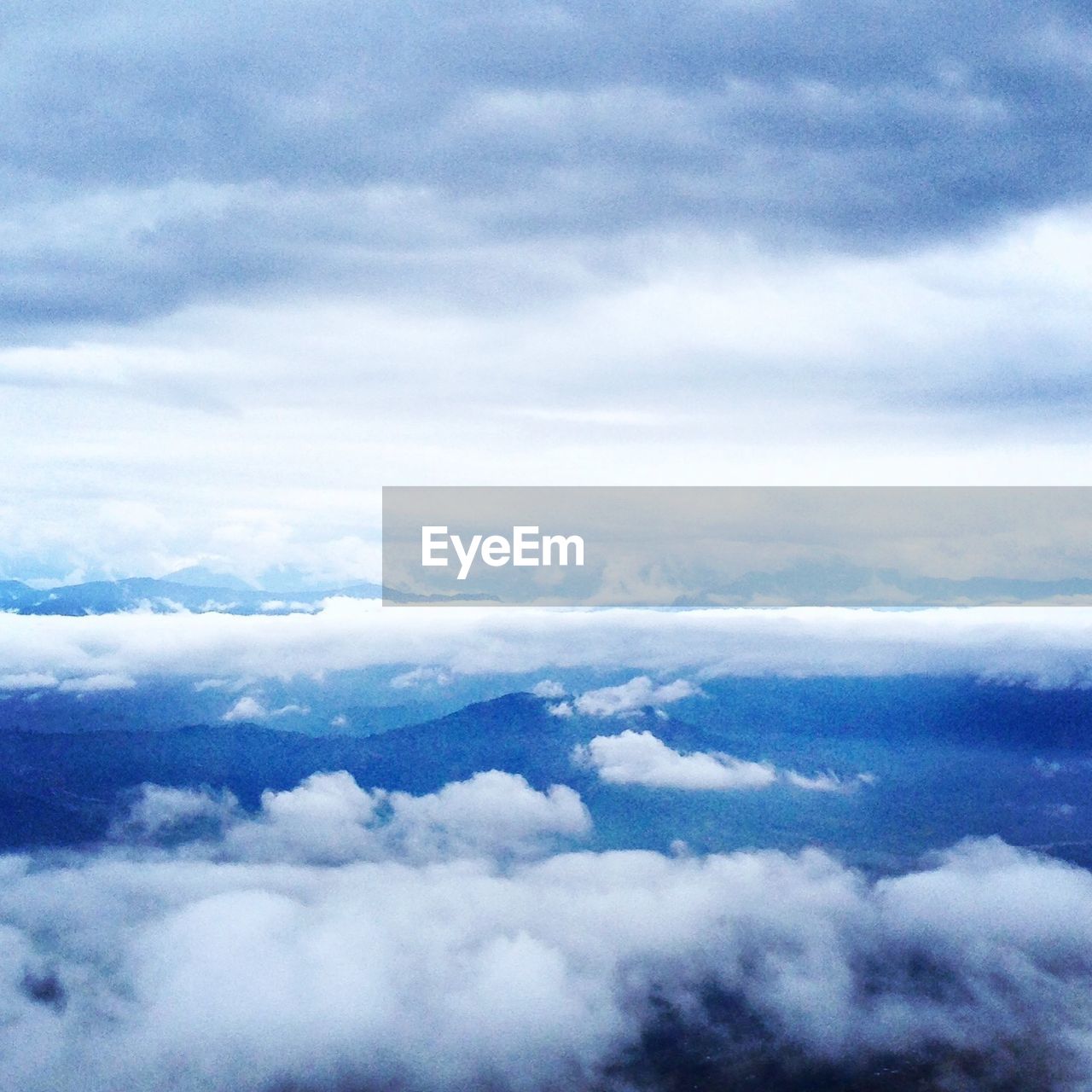 AERIAL VIEW OF CLOUDS OVER MOUNTAINS