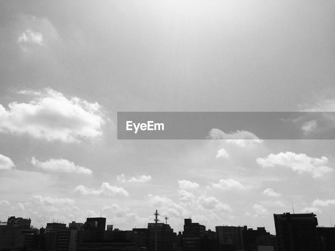 City buildings against cloudy sky