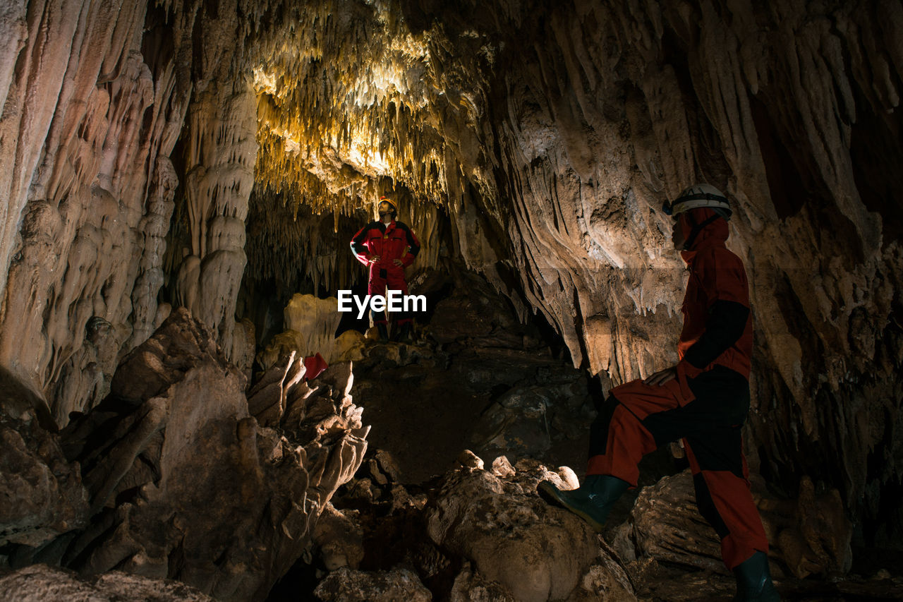 Men standing in cave