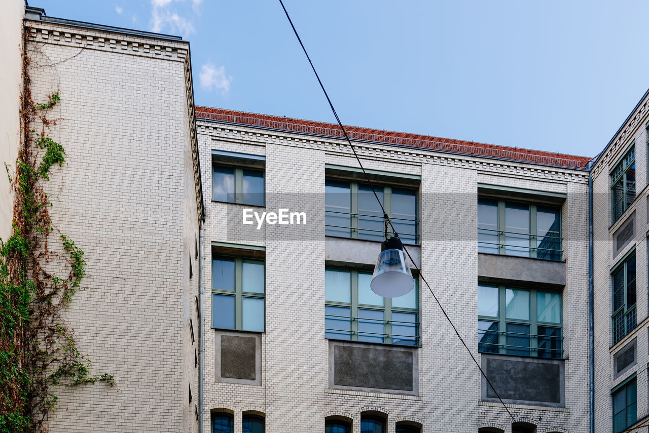 Low angle view of buildings against clear blue sky