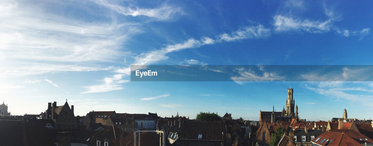 VIEW OF BUILDINGS AGAINST CLOUDY SKY