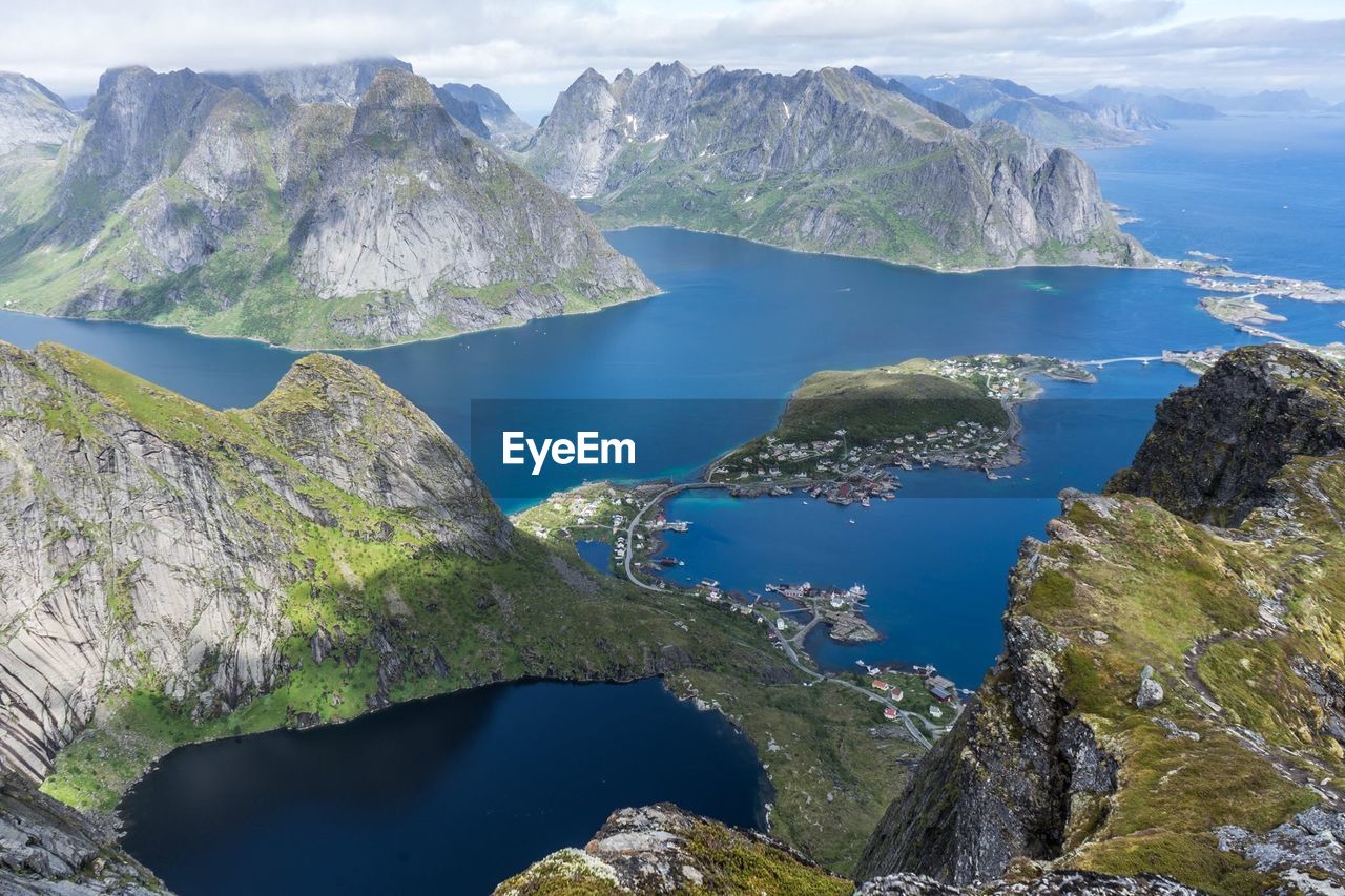 Scenic view of sea and mountains against sky