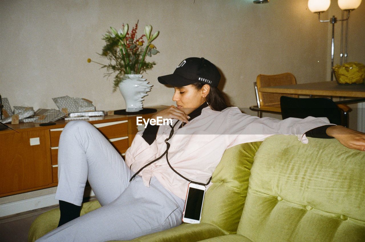 MAN SITTING ON SOFA AT HOME