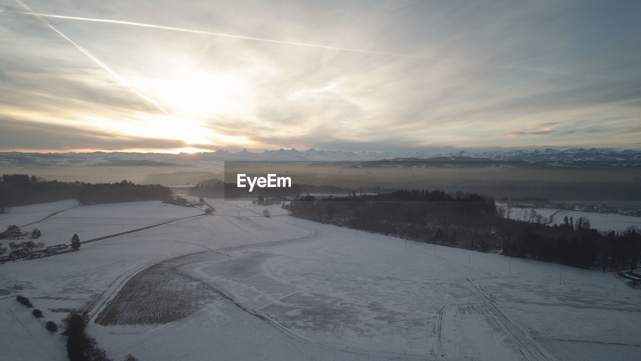 SNOW COVERED LANDSCAPE DURING SUNSET