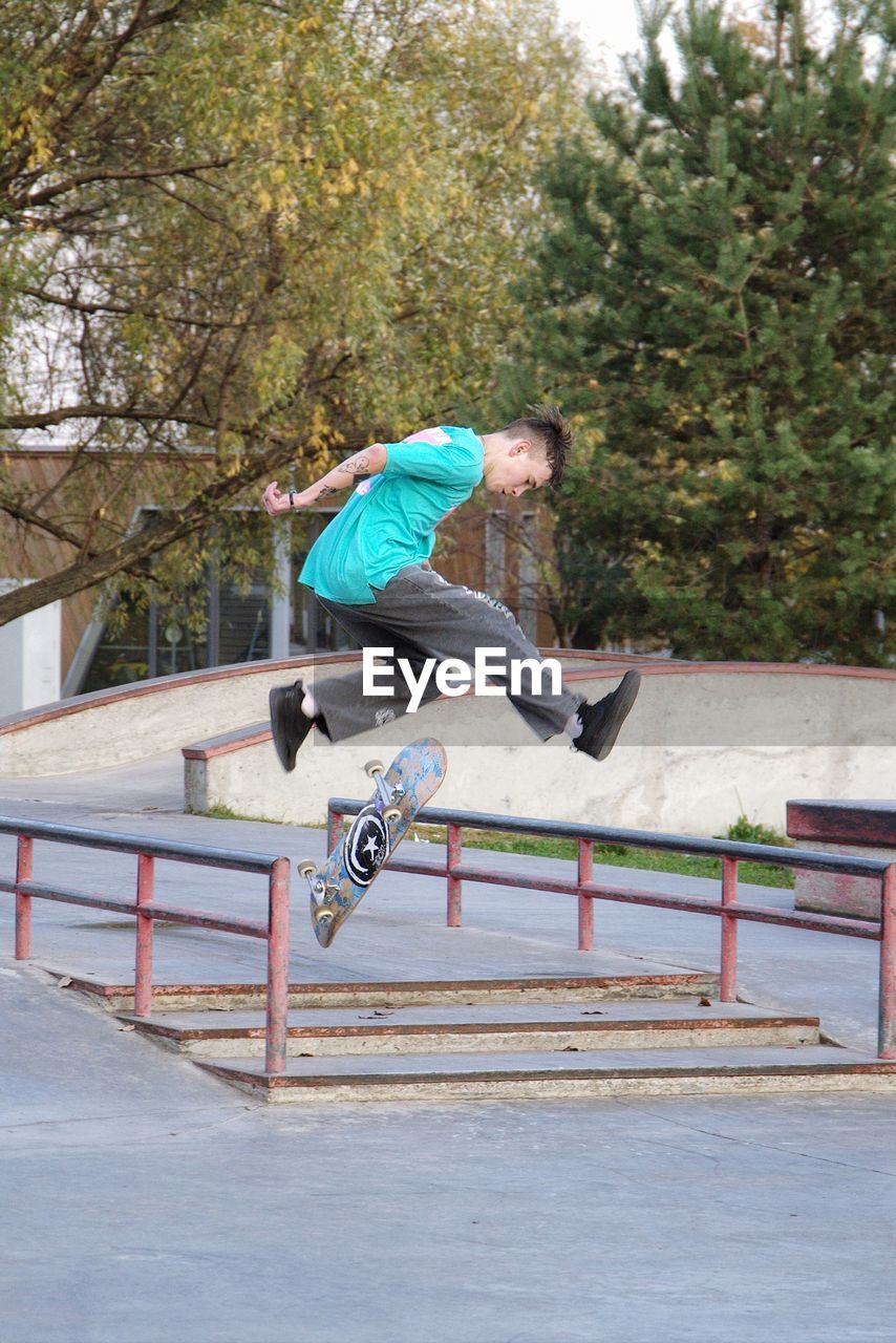 MAN SKATEBOARDING ON UMBRELLA