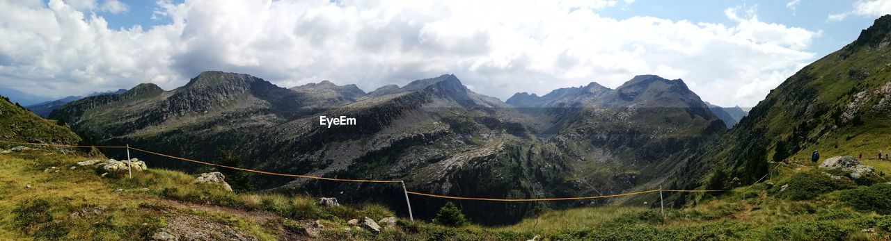 PANORAMIC VIEW OF LAND AND MOUNTAINS AGAINST SKY