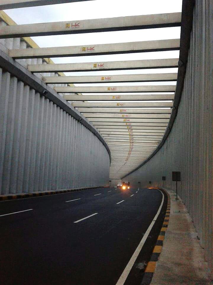 EMPTY ROAD WITH TREES IN BACKGROUND