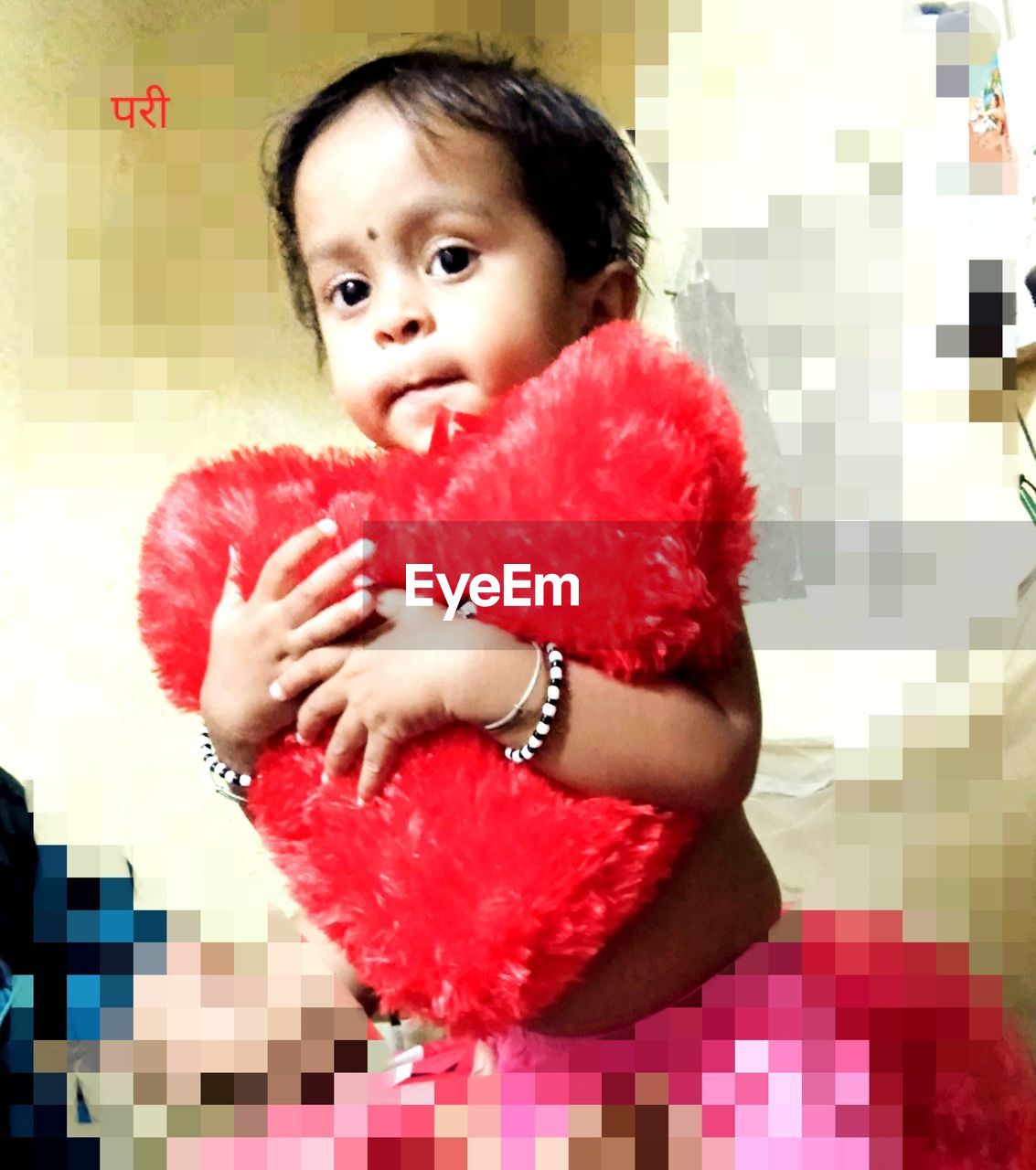 PORTRAIT OF CUTE BABY GIRL ON TILED FLOOR