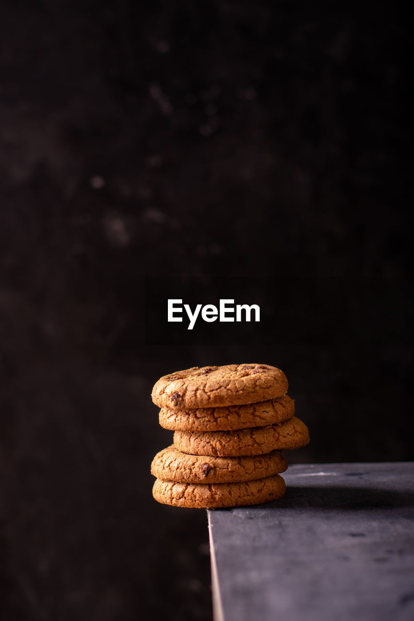 A stack of chocolate cookies on the edge of the table