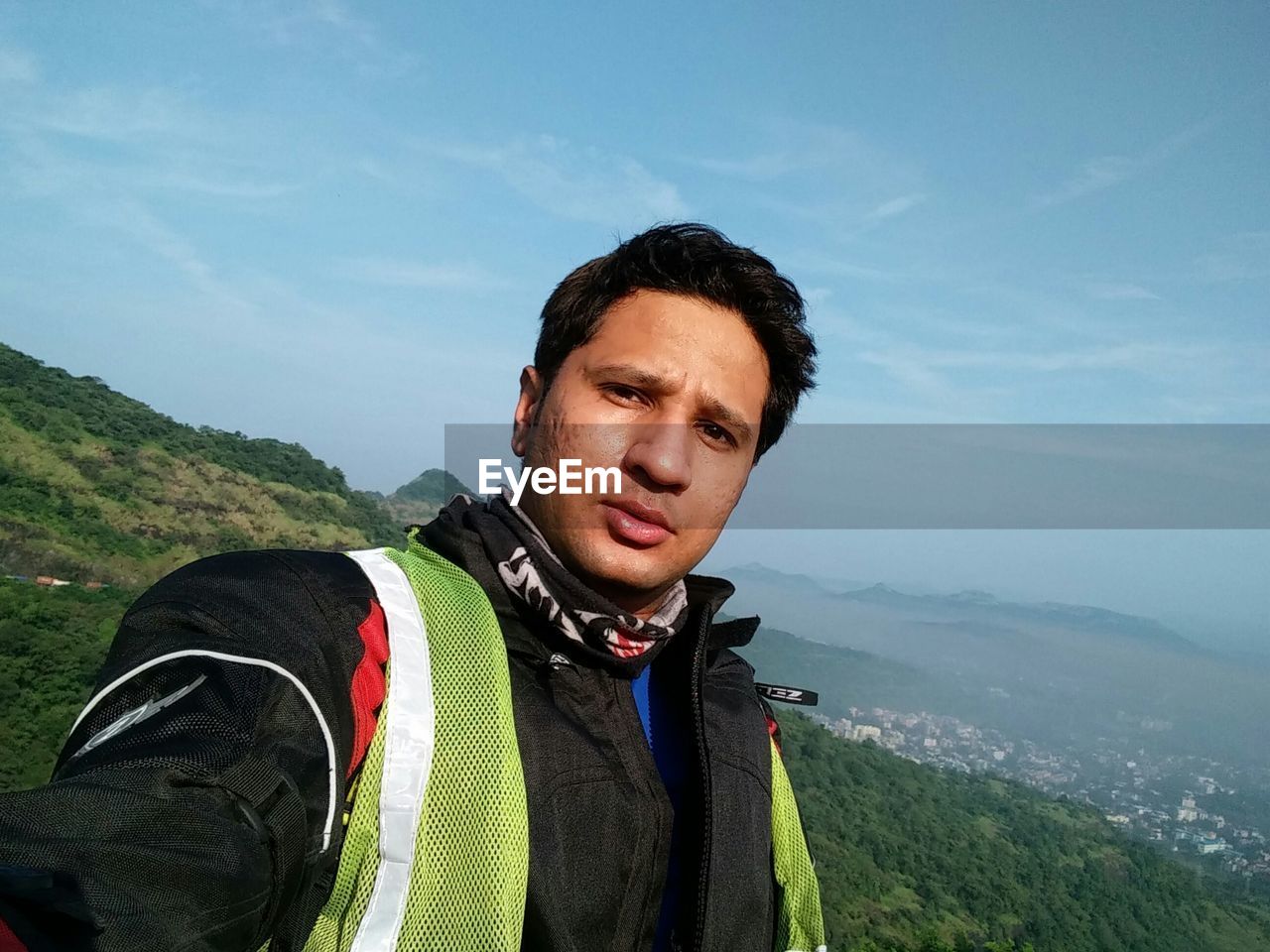 PORTRAIT OF YOUNG MAN IN MOUNTAINS