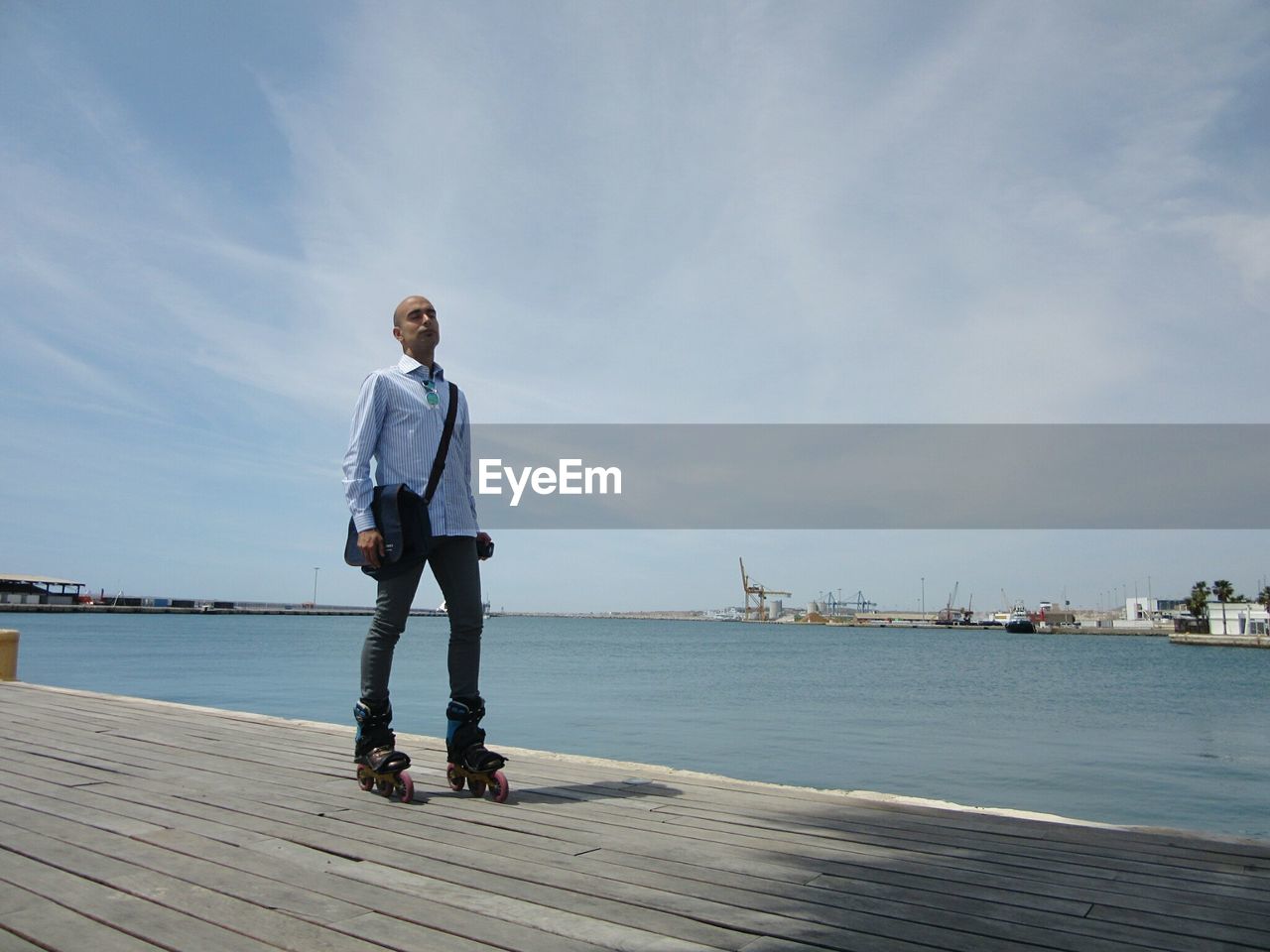 Full length of man inline skating against sea