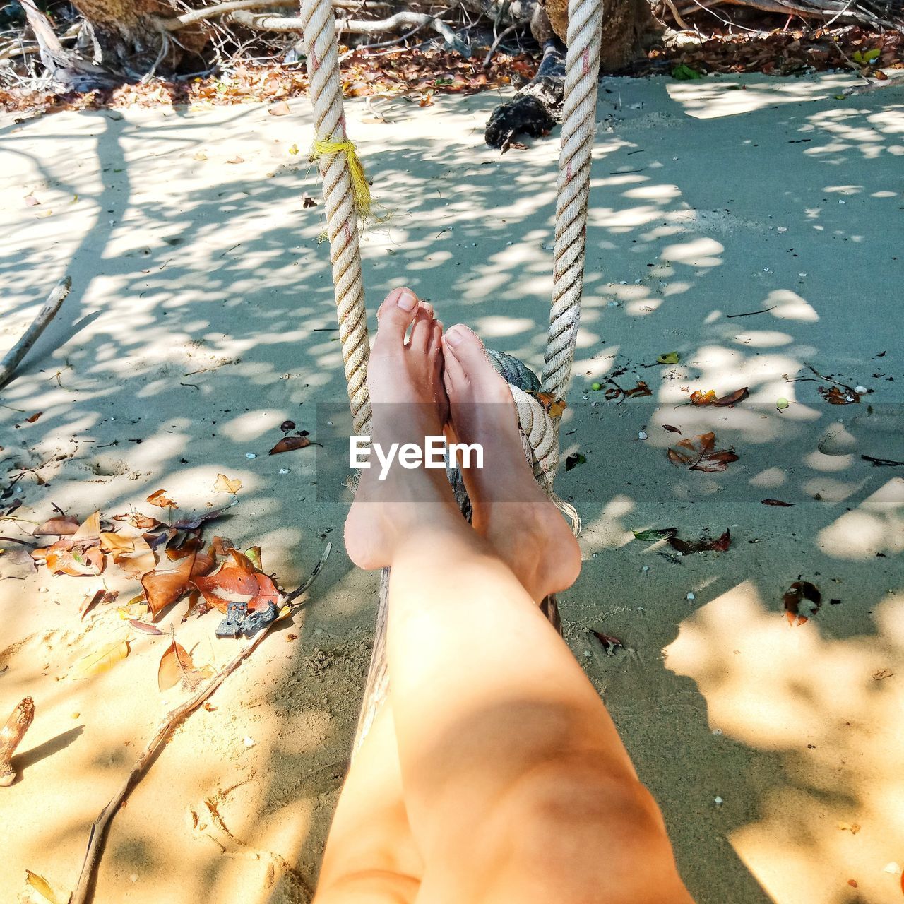 Low section of person legs on rope