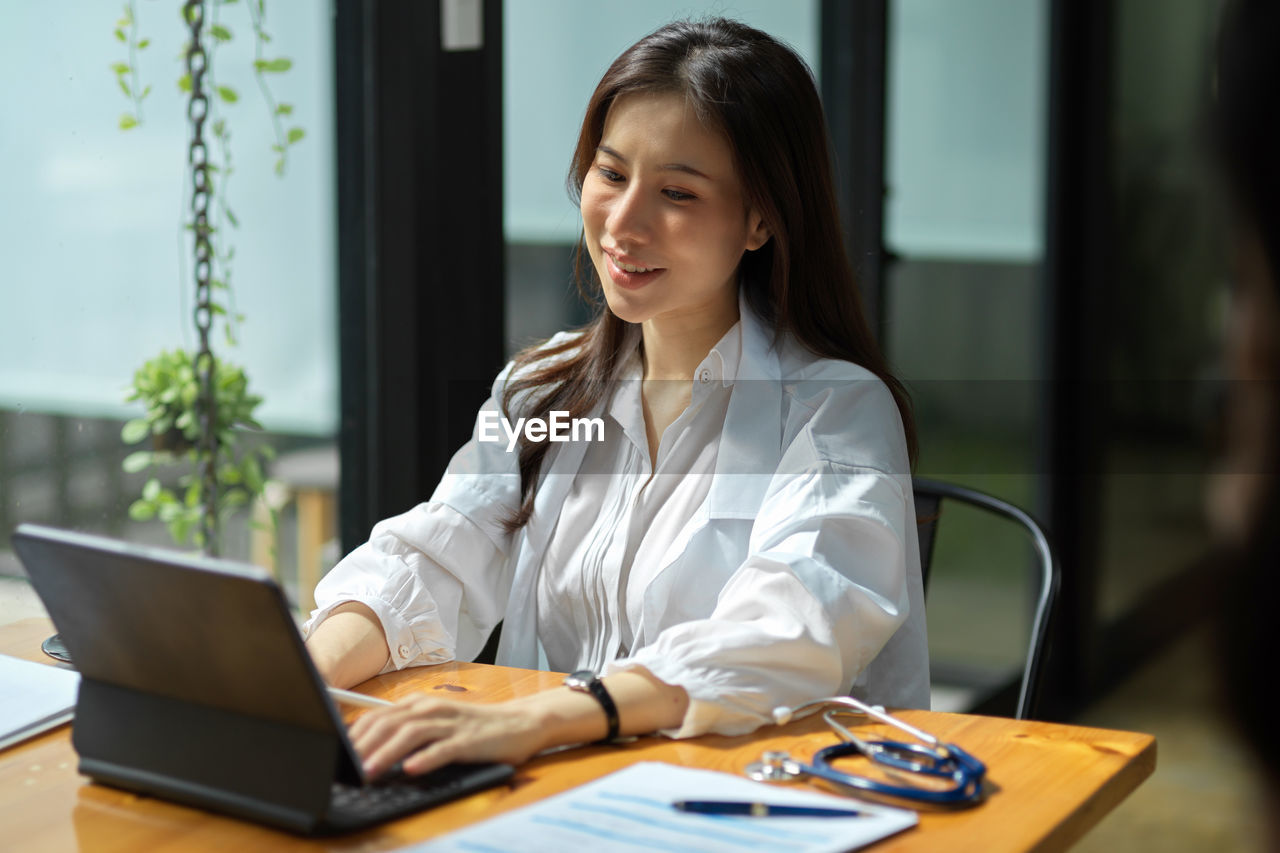 young woman using laptop while sitting at home