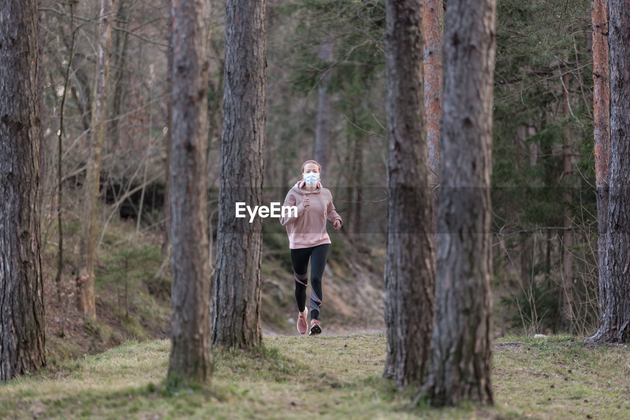 Full length of woman running in forest