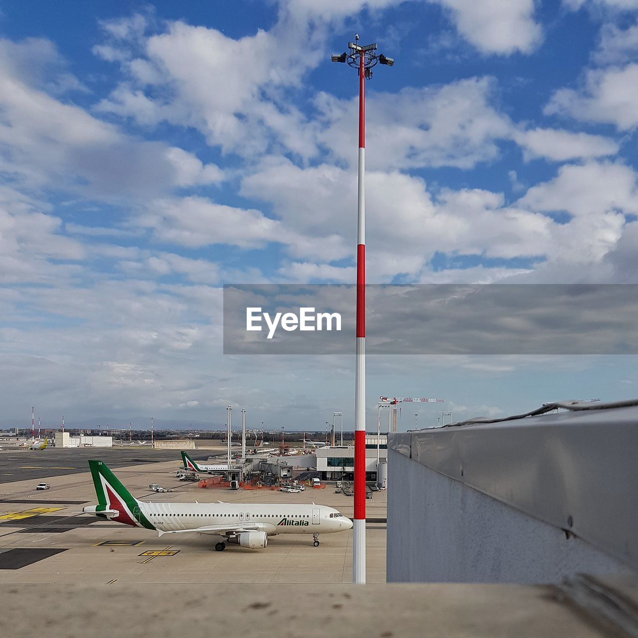 AIRPLANE ON AIRPORT AGAINST SKY