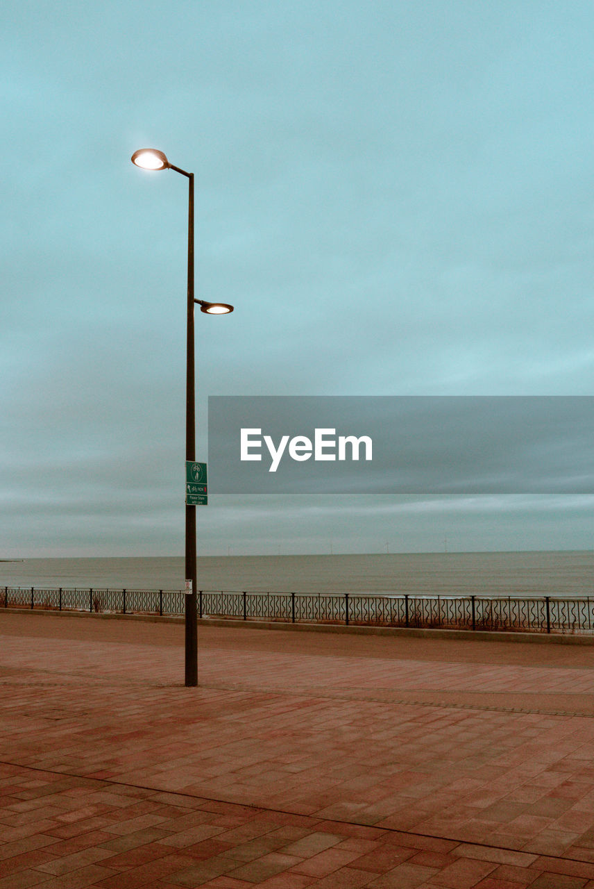 sky, street light, lighting equipment, horizon, nature, water, sea, beach, walkway, cloud, wind, land, street, boardwalk, beauty in nature, no people, scenics - nature, pier, tranquility, outdoors, coast, day, architecture, tranquil scene, lighting, absence, ocean, environment, built structure, copy space