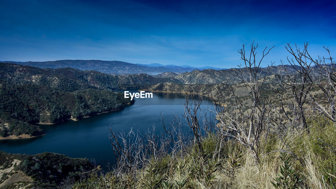 Scenic view of lake against blue sky