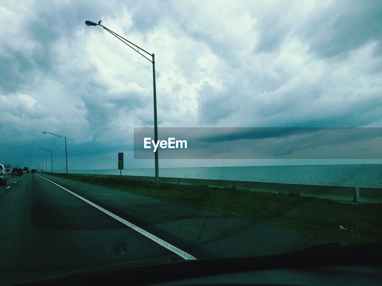 ROAD PASSING THROUGH CLOUDY SKY