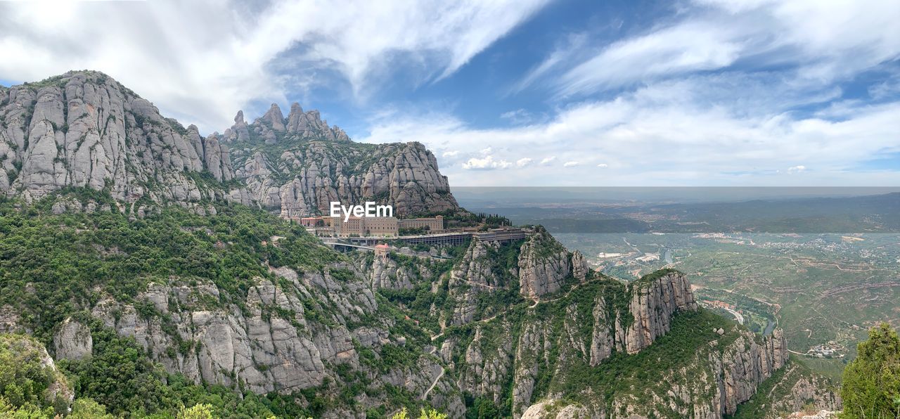 Scenic view of mountains against cloudy sky