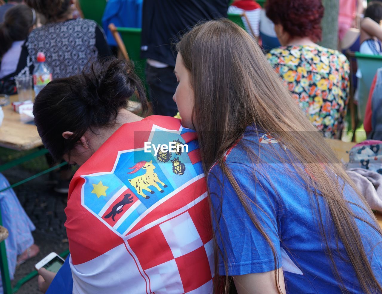 REAR VIEW OF PEOPLE IN TRADITIONAL CLOTHING OUTDOORS