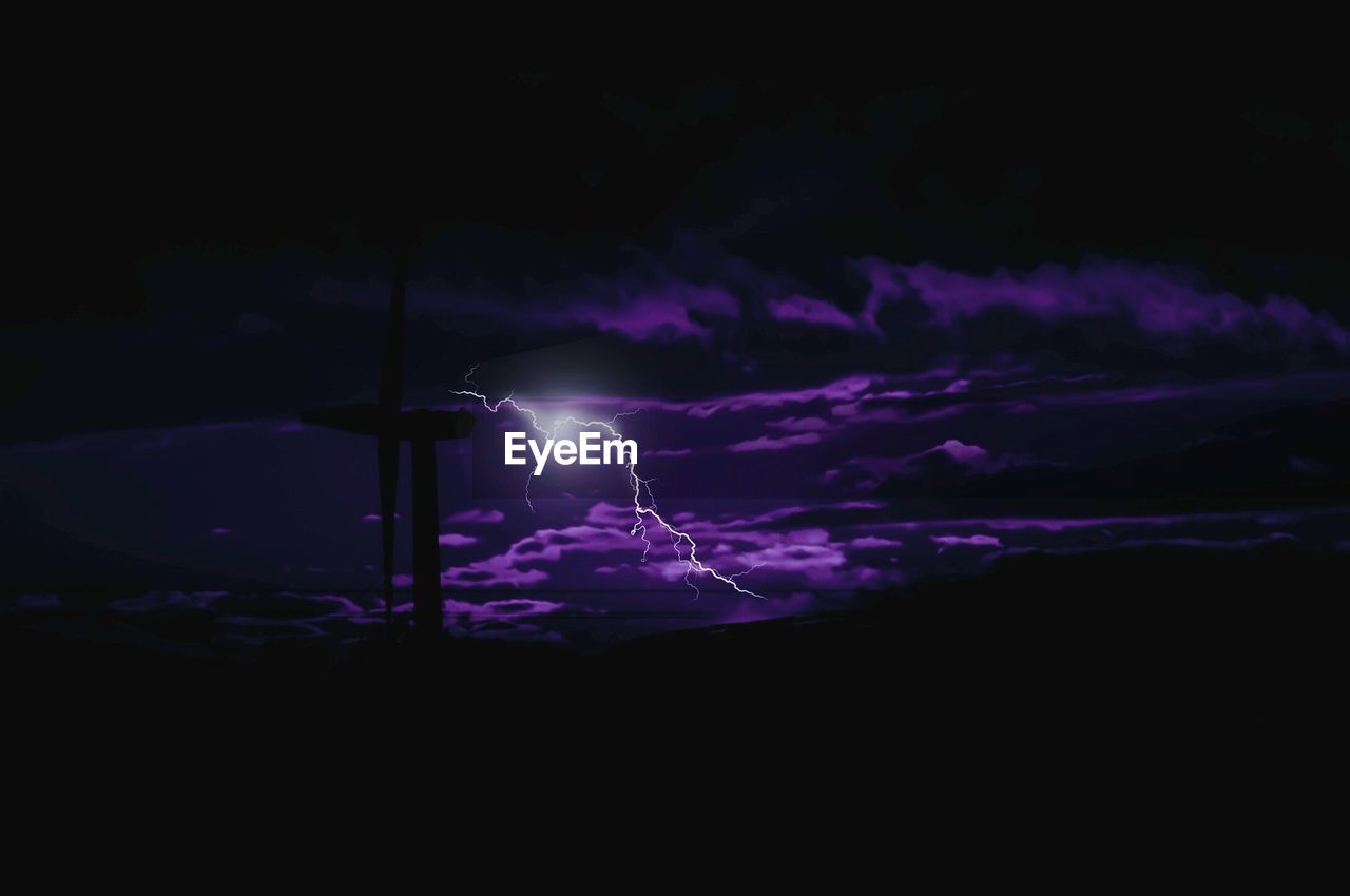 Low angle view of lightning against cloudy sky at night