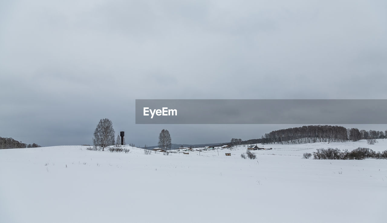 Snow covered land against sky