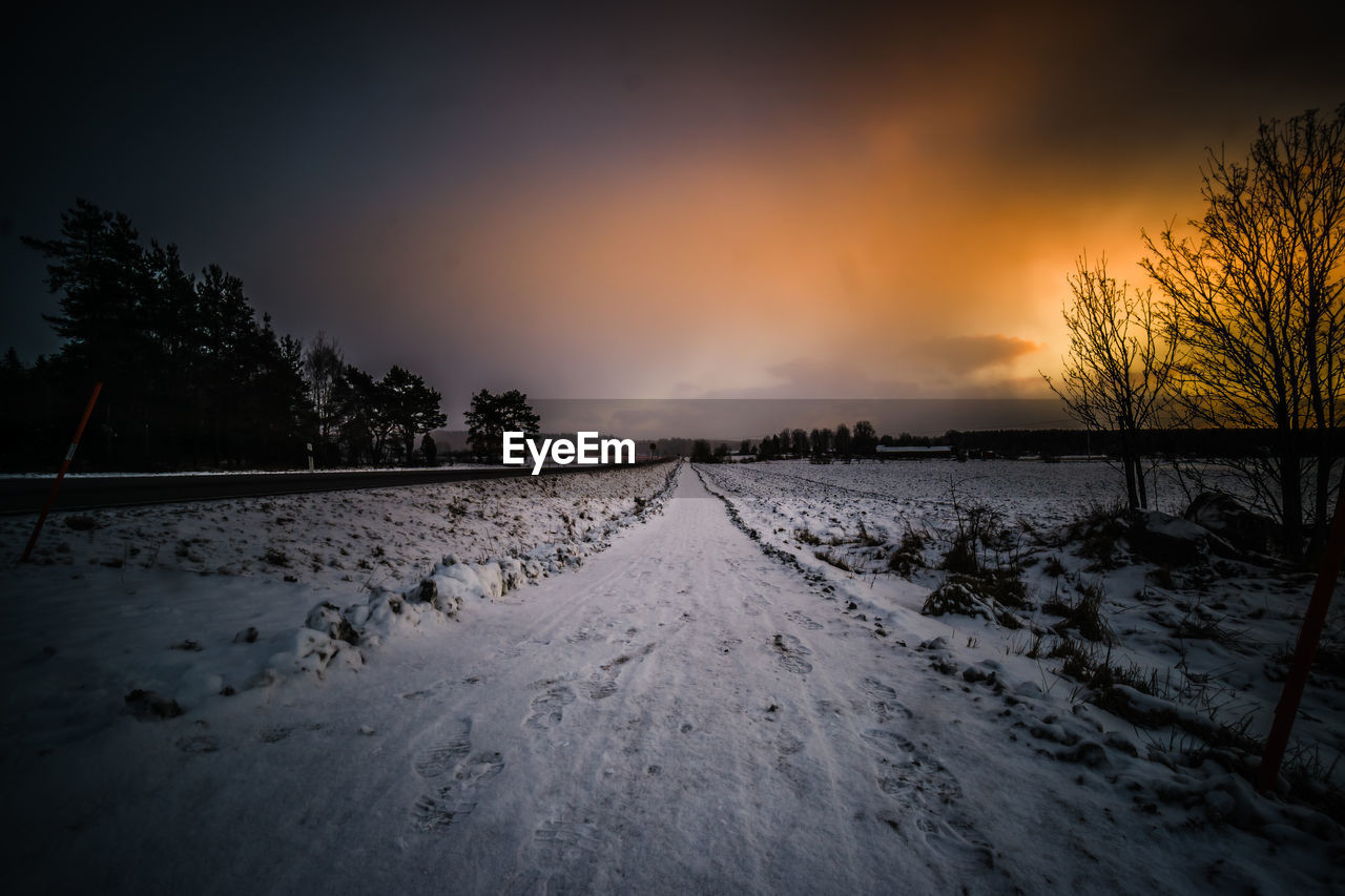 SNOW COVERED LANDSCAPE AGAINST SKY