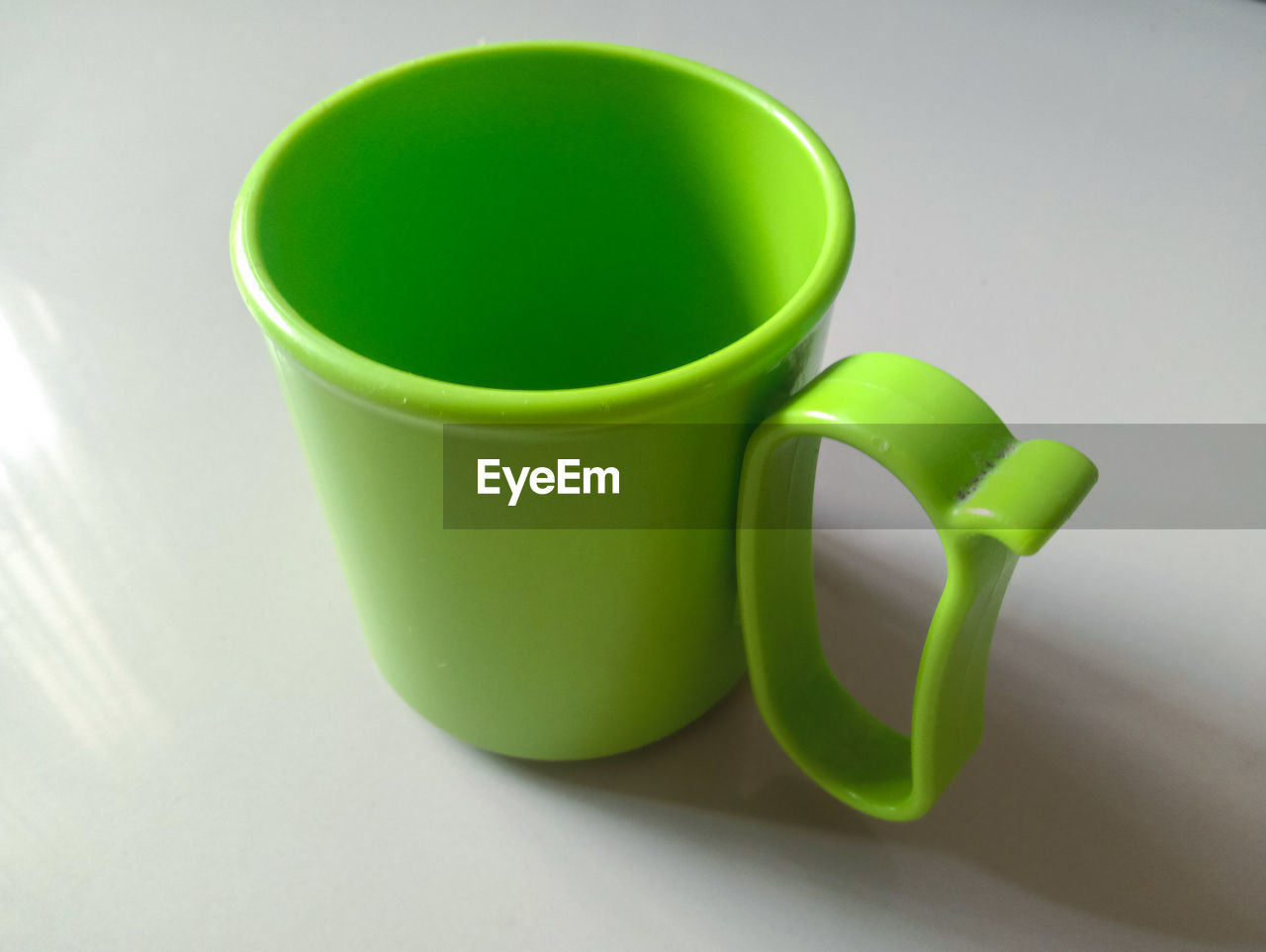 green, cup, coffee cup, indoors, drink, mug, food and drink, no people, ceramic, refreshment, yellow, tableware, still life, close-up, studio shot, high angle view, tea cup, tea, flowerpot