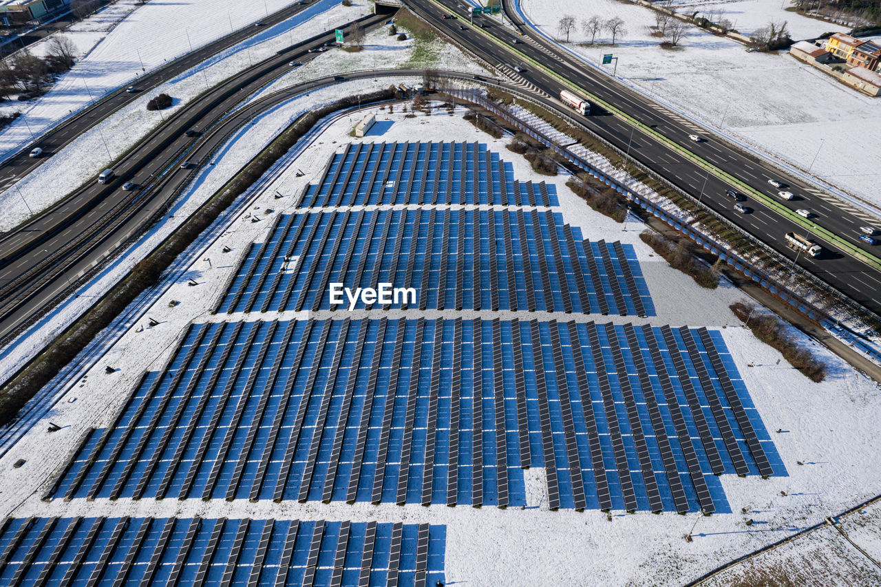 power generation, solar panel, solar energy, alternative energy, renewable energy, environmental conservation, architecture, technology, environment, high angle view, built structure, industry, business, nature, environmental issues, finance, solar power, outdoors, sun, day, transportation, sport venue, roof, stadium, economy