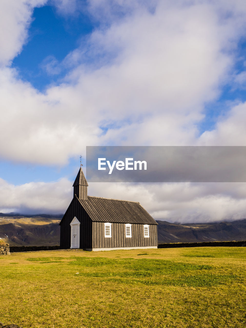 Barn on field against sky