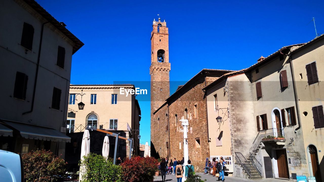 LOW ANGLE VIEW OF BUILDINGS AGAINST CLEAR BLUE SKY